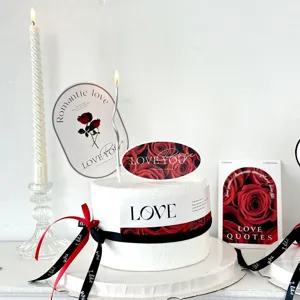 Valentine's Day cake decoration set with romantic rose paper toppers, candles, and ribbons.