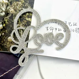 Rhinestone Love letter cake topper detailed view, sparkly felt material for romantic party decor.