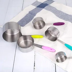 Stainless steel measuring cups set with colorful non-slip handles for kitchen baking.