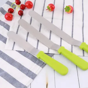 Stainless steel offset cake spatula set with green plastic handles for baking and icing.