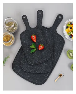 Detailed view of 3-piece black speckled plastic cutting board set with convenient handles for kitchen.