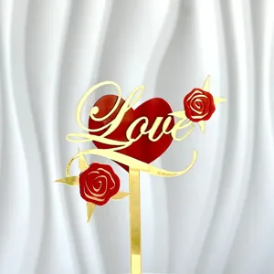 Gold and red acrylic Love cake topper with rose details, perfect for Valentine's Day parties.