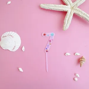 Pink acrylic number 7 cake topper with cute ocean seashell patterns for birthday party.
