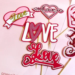 Valentine's Day paper cake toppers with love and heart designs, perfect for romantic party decor.