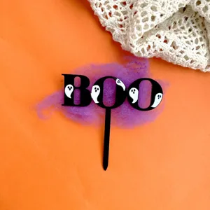 Halloween black acrylic ghost BOO cake topper detail view, spooky party decoration.