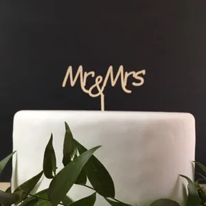 Close-up detail of the rustic wooden Mr and Mrs cake topper showcasing fine wood texture.