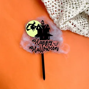 Halloween acrylic cake topper detail, spooky haunted house witch design, party decor.