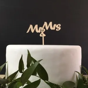 Wooden Mr and Mrs cake topper detail shot, elegant wedding and party dessert decoration.