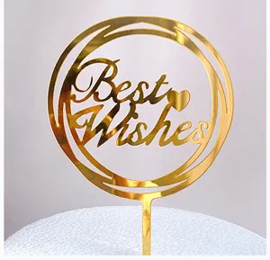 Gold acrylic cake topper detail shot featuring circular cutout and Best Wishes text for parties.