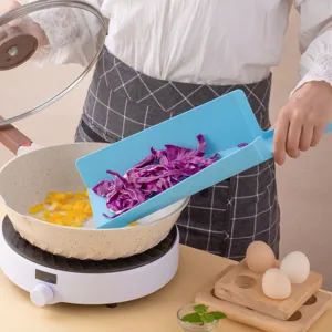 Foldable shovel-shaped plastic cutting board for kitchen food prep and easy vegetable pouring.