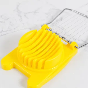 Plastic egg slicer with stainless steel wires, durable yellow base kitchen tool for cutting eggs.