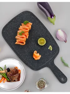 Durable plastic cutting board with comfortable handle for kitchen food prep and slicing.