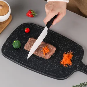Durable plastic cutting board with handle for kitchen food preparation and chopping meat safely.