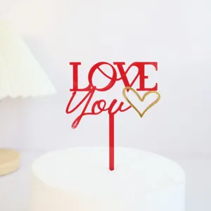 Red acrylic cake topper with LOVE You text and gold heart design for Valentine's Day.