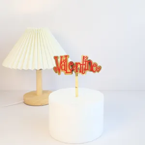 Valentine acrylic cake topper detail, red gold heart design for romantic party dessert decor.