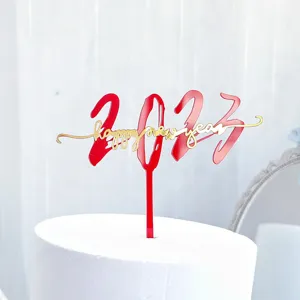 Adorno de tarta de Año Nuevo en acrílico con 2023 y texto dorado, detalle de fiesta.