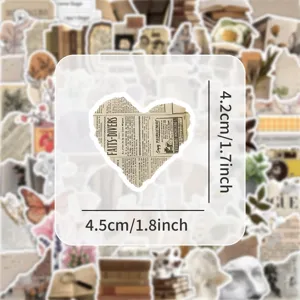 Vintage newspaper heart sticker detail view, perfect for journal scraping, laptop decor.