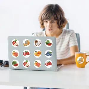 Decorative cute fruit stickers scene showing realistic fruit designs on laptop and mug.