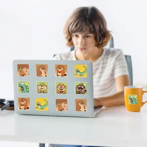 Detailed lifestyle view of cute cartoon beaver stickers displayed on a laptop and mug.