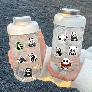 Close-up detail shot of cute cartoon giant panda stickers applied on transparent water bottles outdoors.