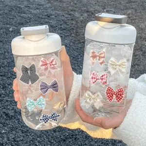 Plastic shaker water bottles decorated with cute bow stickers, portable design for use.