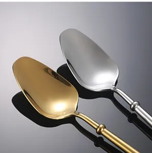 Stainless steel western dessert spoon detail, elegant gold and silver finish, luxury tableware.