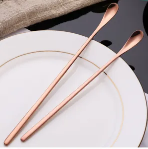 Stainless steel long handle stirring spoon detail shot, rose gold finish for coffee and dessert.