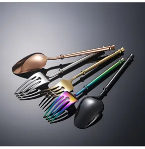 Detailed view of long handle stainless steel spoons and forks with sleek metallic finish.