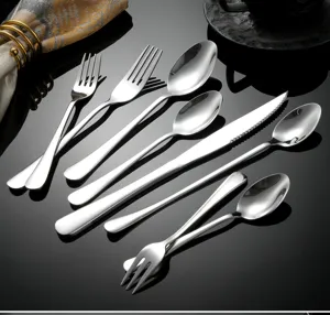 Stainless steel cutlery set with polished finish, includes steak knives, forks and spoons.