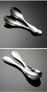 Stainless steel child spoon and fork set detail close-up, premium reflective display