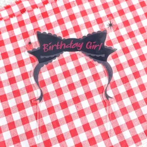 Black bow acrylic birthday cake topper detail, cute party decoration insert for sweet dessert.