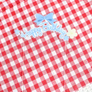 Acrylic cake topper with blue bow and Happy Birthday print, perfect for birthday party decor.