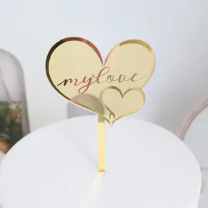 Gold mirror acrylic heart cake topper with engraved text for romantic Valentine's Day party.