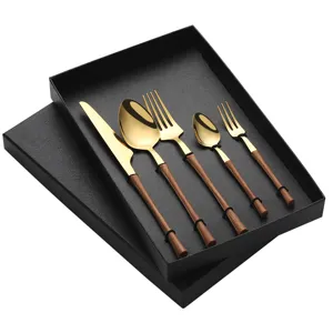 Stainless steel cutlery set with gold finish and wood grain handles, elegant tableware presentation.