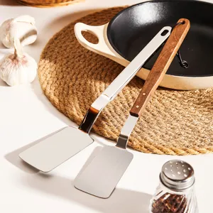 Stainless steel small kitchen spatula set with wooden handle for cooking steak and eggs.