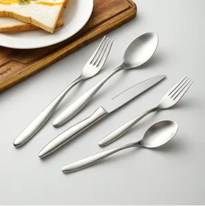 Stainless steel flatware cutlery set detail shot showing matte finish fork, spoon, and knife.