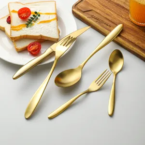 Matte gold stainless steel flatware set, elegant dinner knife fork spoon for kitchen table.