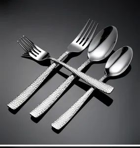 Stainless steel hammered cutlery set, elegant western dinner forks and spoons for dining.