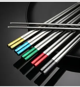 Stainless steel chopsticks detail shot, anti-slip tip design with multi-color accents.