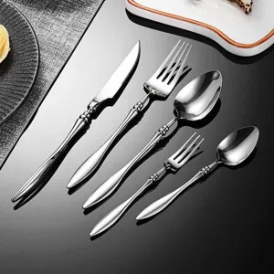 Detailed view of luxury 304 stainless steel western cutlery set, elegant fork, knife, spoon.