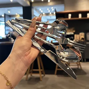 Stainless steel flatware detail view, diamond cut handle design, elegant table cutlery close up.