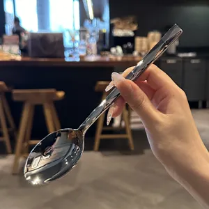 Detailed view of mirror polished stainless steel spoon with sophisticated diamond cut handle.