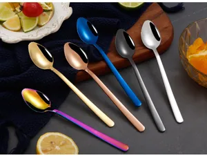 Close-up detail shot of colorful stainless steel fruit spoons with serrated scraping edge.