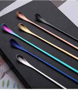 Detailed view of colorful stainless steel long handled stirring spoons, elegant bar and coffee spoons.