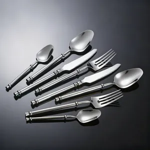 Stainless steel flatware set featuring knives, forks, and spoons with polished silver finish.