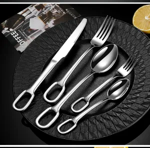 Stainless steel cutlery set with creative hollow handle design, elegant silver finish for dining.