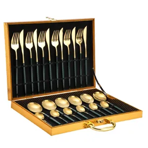 Luxury stainless steel cutlery set with gold finish and dark handles in gift box detail