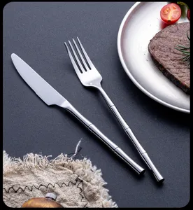Ensemble de couteaux et fourchettes à steak en acier inoxydable avec détail poignée bambou.