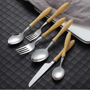 Japanese style wooden handle stainless steel cutlery set including knife, fork and spoon.