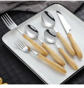 Detailed view of stainless steel cutlery set featuring elegant wood grain handles on a white plate.